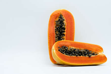 Half of ripe papaya fruit with seeds isolated on white background with copy space. Natural source of vitamin C, folate and minerals. Healthy food for pregnant and breast feeding womanの写真素材