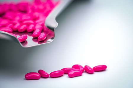 Love vitamins for valentines day concept. Pink tablets pills on stainless steel drug tray.の写真素材