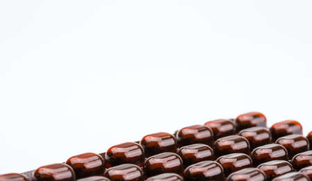 Tablets pills medicine in light resistant blister pack on white background with copy space . Vitamins and minerals tablets pills for pregnant women. Ferrous fumarate anemia treatment tablets pills.の写真素材