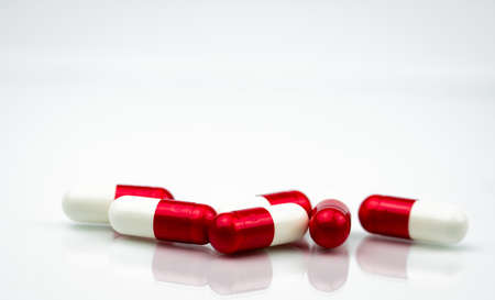 Selective focus of antibiotic capsules pills on white background with copy space. Drug resistance concept. Antibiotics drug use with reasonable and global healthcare concept.の写真素材