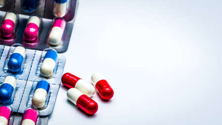 Antibiotics capsule pills in blister pack isolated on white background with copy space for text. Antibiotics drug resistance and antimicrobial drug use with reasonable concept. Global healthcare.の写真素材