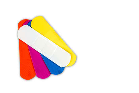 Macro shot detail of first aid dressing (Plaster) with non-stick pad for quick wound healing. Colorful set of sterile wound dressing isolated on white background with copy space for text.の写真素材