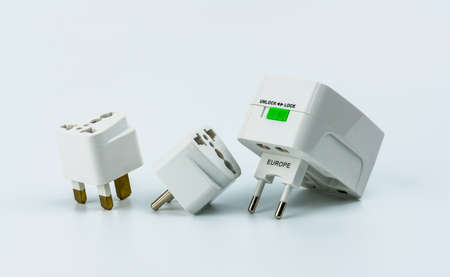 Set of universal plug adapters for travel around the world isolated on white background.の写真素材