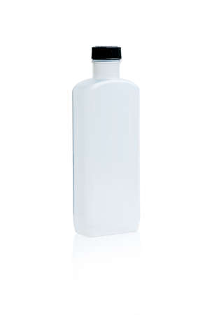 White medicine bottle with black cap and blank label isolated on white background with copy space. PET (Polyethylene terephthalate) plastic bottle container use in pharmaceutical industry packaging.の写真素材