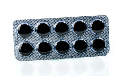 Activated charcoal tablets pills in blister pack isolated on white background with copy space for...