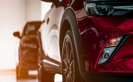 New luxury SUV compact car parked in modern showroom for sale. Car dealership office. Car retail shop. Electric car technology and business conceptの写真素材