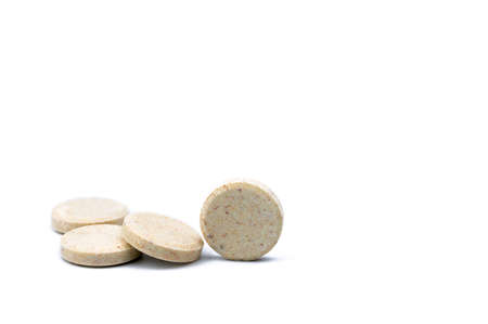 Sweetened flavored milk tablets isolated on white background with copy space for text. Calcium food products from cow milk for healthy bone. Healthy snack for children.の写真素材