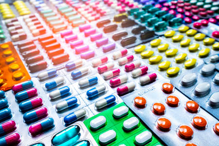 Colorful of tablets and capsules pill in blister packaging arranged with beautiful pattern with flare light. Pharmaceutical industry concept. Pharmacy drugstore. Antibiotic drug resistance.の写真素材