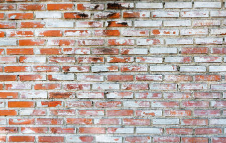 Empty old brick wall texture background with copy space. Peeling plaster texture. Vintage brick wall background. Abstract for web banner.の写真素材