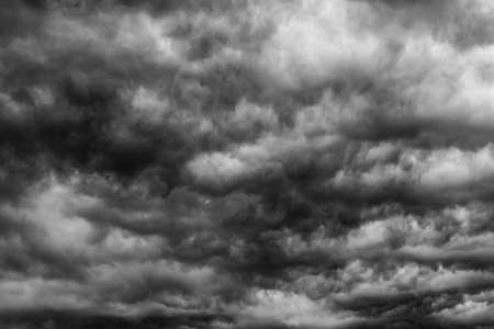 Dramatic dark sky and clouds. Cloudy sky background. Black sky before thunder storm and rain. Background for death,  sad, grieving or depression.の写真素材