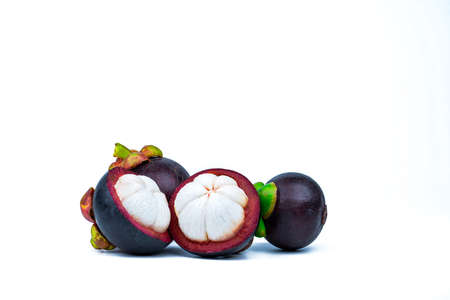Two whole purple mangosteen and two cross section isolated on white background. Tropical fruit from Thailand. The queen of fruits. Asia fresh fruit market. Natural source of tannin and xanthonesの写真素材