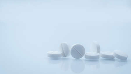 7 white round tablets pill isolated on white background with beautiful and unique pattern with copy...