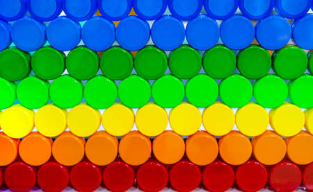 Colorful plastic bottle cap arrange with beautiful tone and pattern. Blue, green, yellow, orange,...