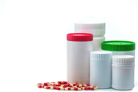Antibiotic capsule pills with blank label plastic bottle container isolated on white background. Pharmaceutical industry. Pharmacy background. Antimicrobial drug resistance. Global healthcare concept.の写真素材