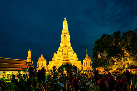 Wat Arun Ratchawararam at sunset with beautiful blue sky and purple clouds. Wat Arun buddhist temple is the landmark in Bangkok, Thailand. Attraction art and ancient architecture in Bangkok, Thailand.のeditorial素材
