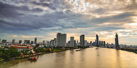 Cityscape of modern building near the river in the morning . Modern architecture office building. Skyscraper with morning sky. Riverfront building and city. High rise building in downtown.のeditorial素材