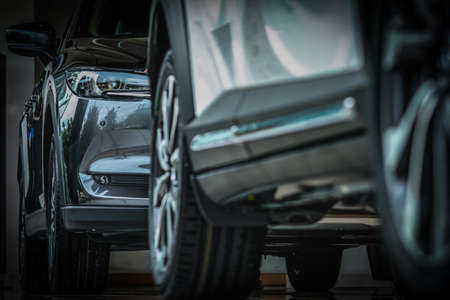 New luxury black shiny SUV compact car parked in modern showroom. Car dealership office. Car retail...