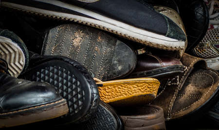 Close up of old dirty male shoes. Used shoes. Heap of old shoes. Many of dirty men shoe. Men shoes...