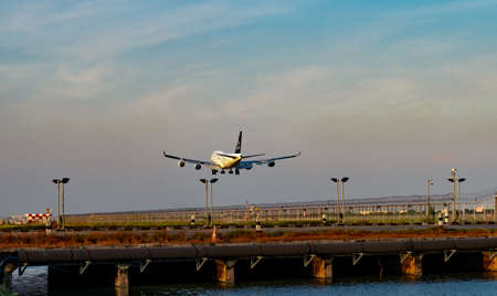 BANGKOK, THAILAND-DECEMBER 3, 2018 : Star Alliance Airlines. Passenger plane is landing at Suvarnabhumi Airport in Thailand. Fence and solar cell panels at the airport. Drainage canal. Boeing 747.のeditorial素材
