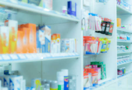 Blurred picture of medicine shelf in drug store. Pharmacy shop interiors. Pharmaceutical products in drugstore. Medical retail shop. Pharmacy in hospital. Healthcare business. Drug display shelf.の写真素材