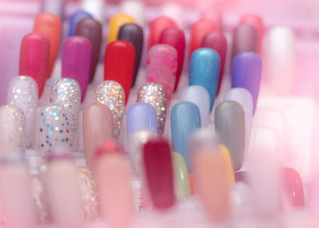Colorful artificial Nails in nail salon shop. Set of false nails for customer to choose color for manicure or pedicure in nail salon and spa shop. Nails art and design. Sample nail polish palette.の写真素材