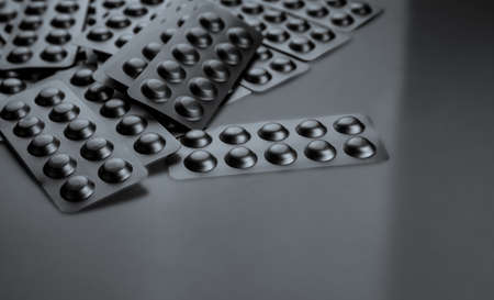 Tablets pill in blister pack on gray background. Pills in silver aluminium foil blister pack....