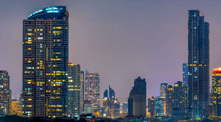 Cityscape of modern building near the river in the night. Modern architecture office building. Skyscraper with evening sky. Night photography of riverfront building. Condominium open light in night.の写真素材