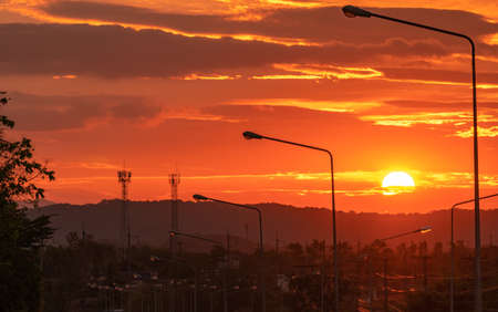 Beautiful sunrise over mountain in the morning. View from the road and electric pole and cable wire....