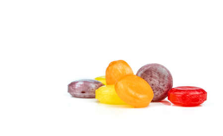 Medical lozenges for relief cough, sore throat and throat irritation isolated on white background. Colorful of cough lozenges. OTC products in pharmacy shop. Orange, red, purple, and yellow lozenges.の写真素材