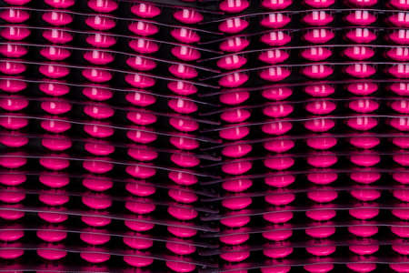 Stack of pink tablet pills of ibuprofen medicine for treatment migraine headache, high fever, anti-inflammatory, arthritis, muscle pain. Non-Steroidal Anti-Inflammatory drug. Blister pack of pills.の写真素材