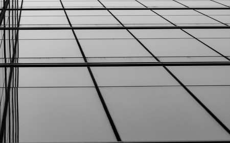 Perspective view of modern futuristic  glass building abstract background. Exterior of office glass building architecture. Reflection in transparent glass of business building. Company glass window.の写真素材