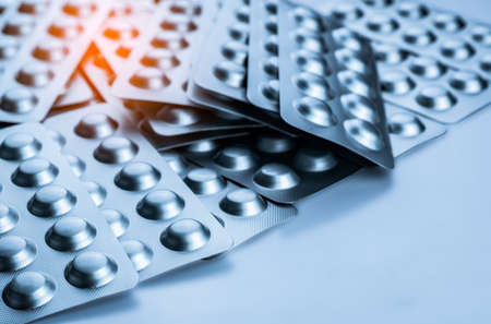 Painkiller and muscle relaxant medicine. Pile of silver aluminium foil blister pack. Pharmaceutics...