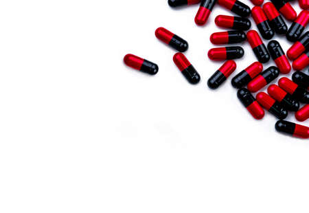 Red-black capsule pills isolated on white background with space for text. Pharmaceutics concept....
