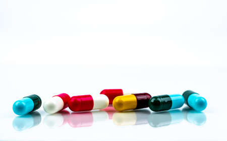 Colorful antibiotic capsule pills on white background. Pharmaceutics concept. Antibiotic drug resistance. Pharmaceutical industry. Pharmacy drugstore. Healthcare medication. Antimicrobial capsule.の写真素材