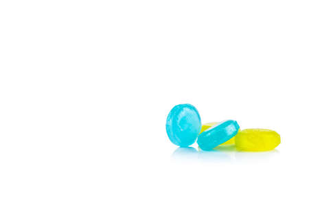Medical for relief cough, sore throat and throat irritation isolated on white background. Cough and colds drop. Colorful cough pastille. Blue and yellow round candy or sweets. Menthol flavour.の写真素材