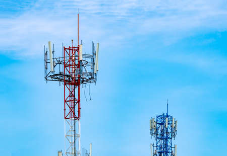 Telecommunication tower with blue sky and white clouds background. Antenna on blue sky. Radio and satellite pole. Communication technology. Telecommunication industry. Mobile or telecom 4g network.