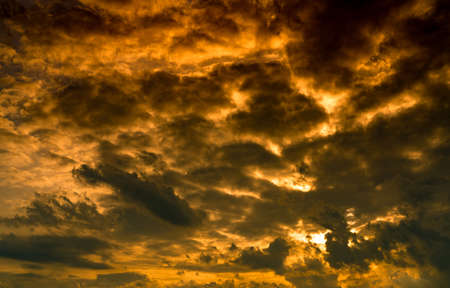 Dramatic golden sunset sky and white cumulus clouds. Cloudy sky. God light concept. Beautiful...