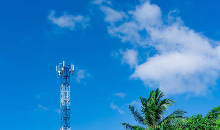 Telecommunication tower with blue sky and white clouds background. Antenna on blue sky. Radio and...