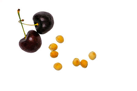 Red cherry with stalk and seed isolated on white background with copy space. Ripe red sweet cherry....