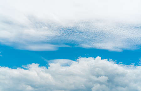 Beautiful blue sky and white cumulus clouds abstract background. Cloudscape background. Blue sky and fluffy white clouds on sunny day. Nature weather. Cotton feel texture. White soft clouds backgroundの写真素材