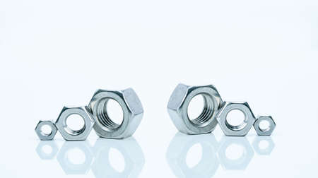 Set of metal hexagon nuts isolated on white background. Small, medium, and big of silver metal...