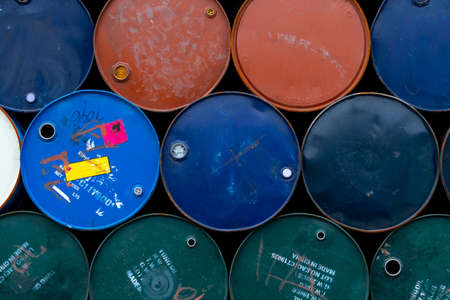 Old chemical barrels. Blue, green, orange oil drum. Steel oil tank. Toxic waste warehouse. Hazard...