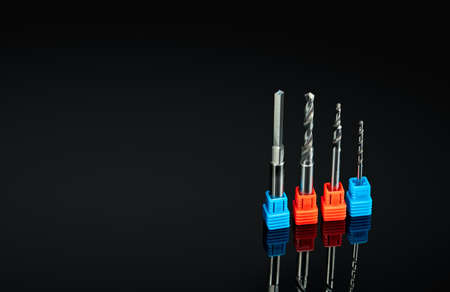 Special tools isolated on black background. Made to order special tools. Coated step drill detail....