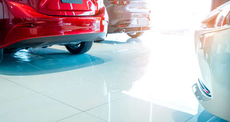 Closeup back view of red SUV car. New and shiny luxury SUV car parked in modern showroom for sale. Car dealership office. Automobile retail shop. Electric car business concept. Automobile leasing.の写真素材