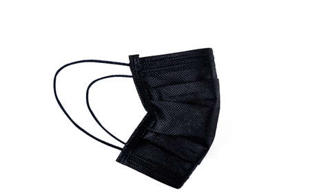 Black surgical or medical face mask isolated on white background. Surgical face mask for coronavirus protection. Disposable earloop face mask for cover mouth to virus and air pollution protective.の写真素材