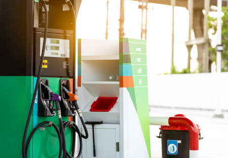 Petrol pump filling fuel nozzle in gas station. Fuel dispenser machine. Refuel fill up with petrol gasoline. Petrol industry and service. Petrol price and oil crisis concept. Petroleum oil industry.の写真素材