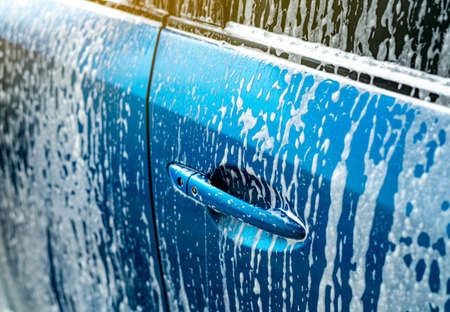 car wash  white soap foam. Auto care business. Car cleaning and shining before waxing service. Vehicle cleaning service  antiseptic and disinfection   (COVID-19). Carwash.の写真素材