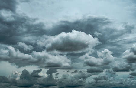 Dark dramatic sky and clouds. Background for death and sad concept. Gray sky and fluffy white clouds. Thunder and storm sky. Sad and moody sky. Nature background. Dead abstract background. Cloudscape.の写真素材