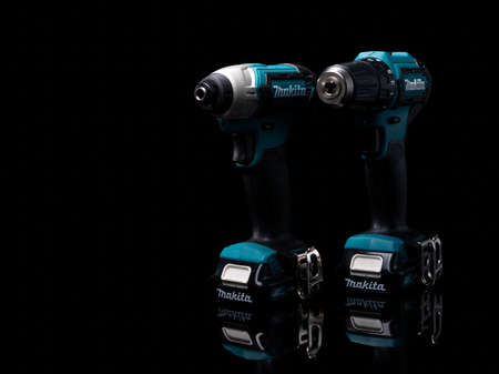 CHONBURI, THAILAND-MAY 24, 2020 : Makita codless driver drill isolated on dark background. Makita tools. Single sleeve keyless driver drill chuck for easy bit installation/removal. Technician tools.のeditorial素材