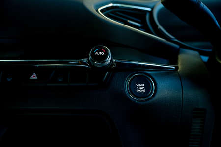 Start stop engine button of luxury car. Push up button for start or stop car engine in keyless...